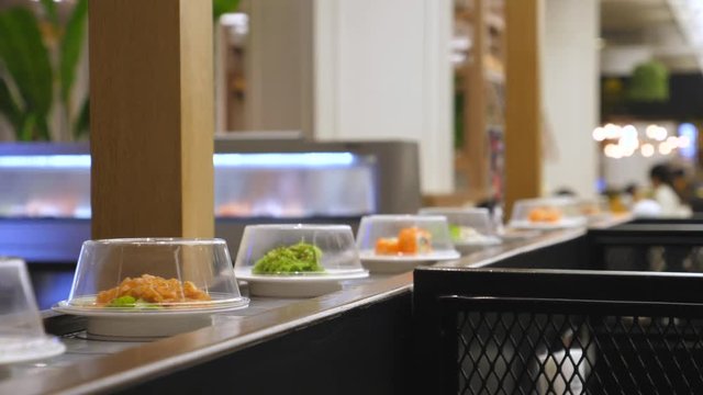 Sushi On Conveyor Belt In Japanese Restaurant