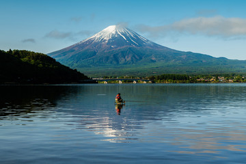 Fuji mountain and Kawaguchiko lake in morning, fog flow on the air and people do activity.