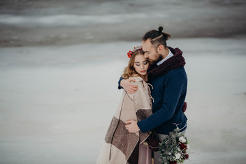 Winter wedding in forest. Portrait of young couple in love in a cold winter day. Love and couple relationships concept. Wedding day and Valentine day.