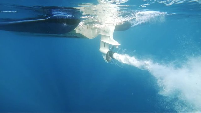 slowmotion shot of boat propeller starts with nice air bubbles turning around the propeller