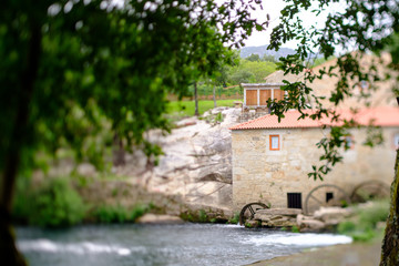 Obraz na płótnie Canvas A picture with a Tilt and shift lens of a mill-house in Vilar de Mouros, Portugal.