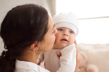 Mother, playing with her toddler boy smiling