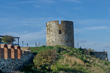 Fototapeta na wymiar Ruined watch tower and stone with brick walls around Western fortification in ancient city Nessebar or Mesembria on the Black Sea coast, Bulgaria, Europe 