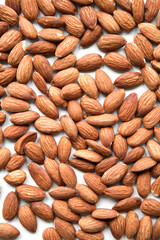 Natural background made in nuts. White background with almonds.