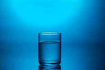 a shot of vodka on a blue background