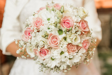 Obraz na płótnie Canvas pastel pink rose and white foliage wedding bouquet