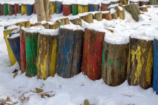 multicolored fence columns under the snow