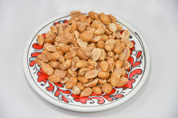 Spicy peanuts,hazelnuts in a porcelain plate