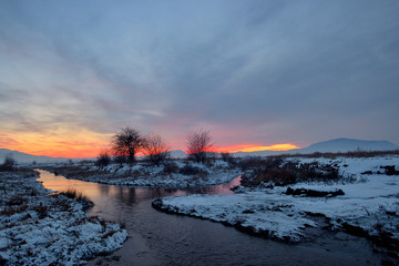 frozen sunset over river