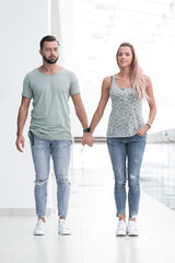 couple standing in the lobby of a modern building