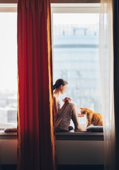 Young girl with a cat at home