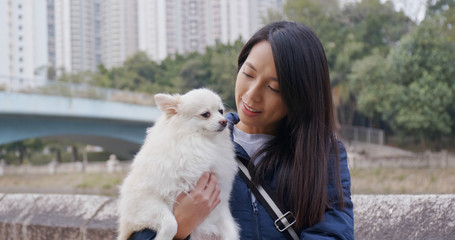 Woman go out with her Pomeranian dog