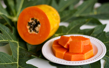 Papaya fruit on leaf background.