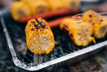 Corn on a disposable grill. Grilled corn.