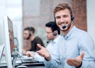 friendly staff with a headset in the workplace in the business center