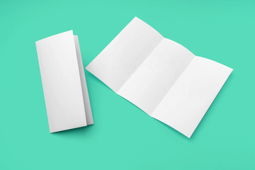 Tri-fold brochure mockup isolated on green background