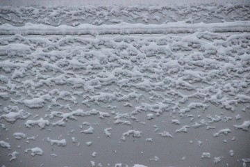 Textured background. Gray steel wall with the snow. snow texture on the surface