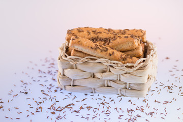 crackers ,Cheese Sticks With Caraway Seed in a wicker basket