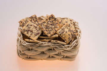 cookies with  poppy seeds and sesame seeds in a wicker basket