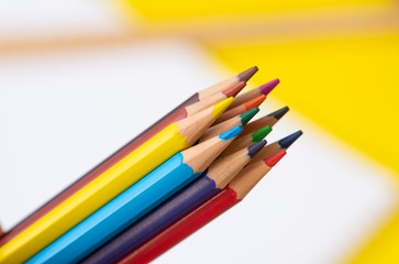 Color pencils, on the yellow background.