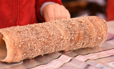 Hungarian Kurtos-Kolac - Kurtos Kalacs,prepared on the grill, at a traditional food fair Specific for Transylvania, Romania
