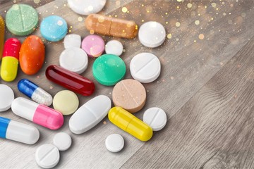 Colorful pills and tablets on background
