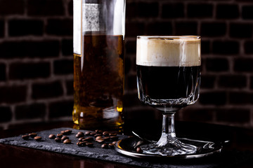 Irish coffee in a bar. Concept of St Patrick holiday. Holiday background. Irish national day. Warm tone. Square