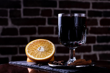 Glasses of delicious mulled wine on color table