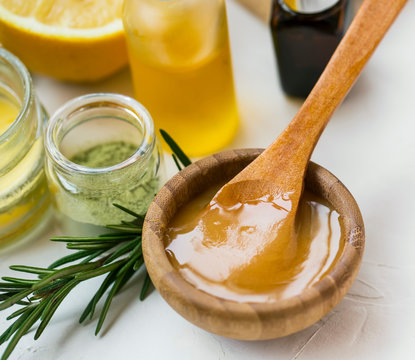 Organic skincare ingredients with manuka honey, oils, clay and rosemary herb, honey closeup