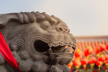Lion statue in front of chinese on temple background, Chinese New Year concept