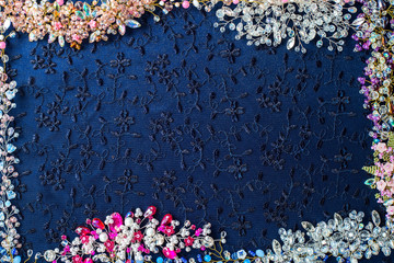 Beautiful shiny background. Crystals, beads, wire, twigs, wedding accessories collected on dark fabric