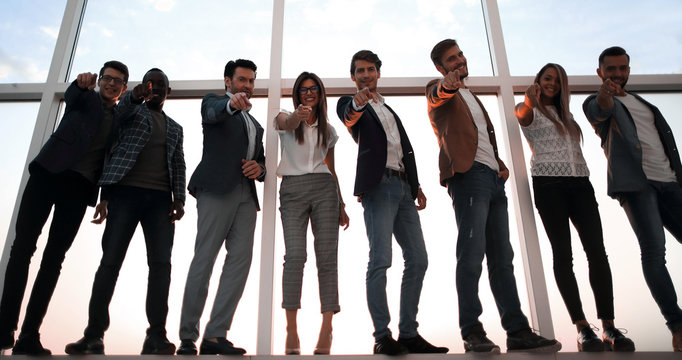 group of young business people pointing at you