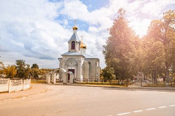 Beautiful white church with golden domes with a blue sky landscape