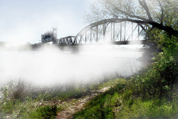 bridge on foggy river