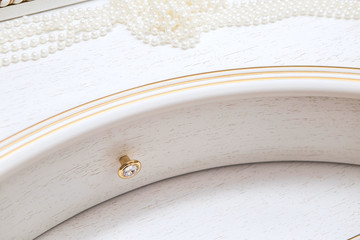 Beautiful lady's bedroom. A set of drawers and pearl decorations. delicate interior detail