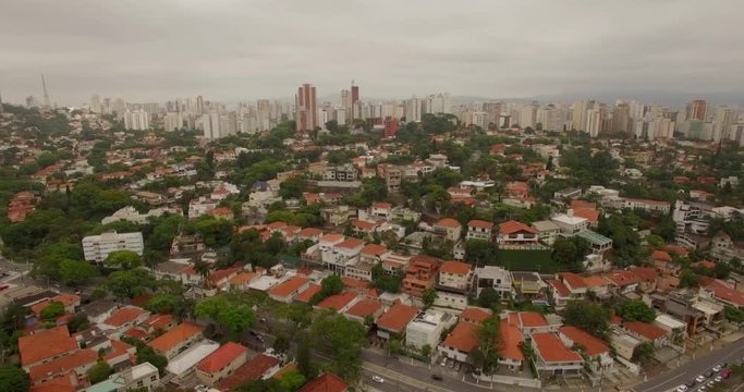 Aerial of residential neighbourhood Sao Paulo Brazil with downtown skyscrapers in the background