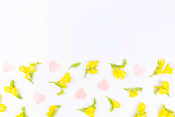 Valentines Day and Mother Day background. Floral pattern made of yellow flowers on white background. Flat lay, top view