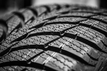 Obraz premium black stylish new tire for cars on wheels