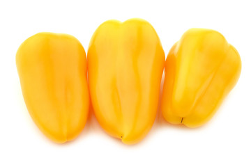 three yellow sweet snack peppers on a white background