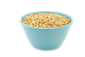 Biological organic buckwheat in a blue bowl on a white background