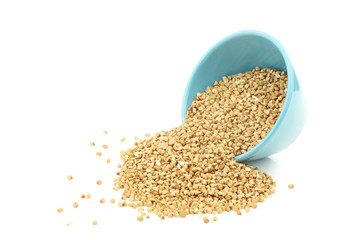 Biological organic buckwheat in a blue bowl on a white background