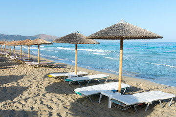 straw parasols on the beach of Falassarna, Crete