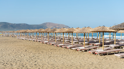 straw parasols on the beach of Falassarna, Crete