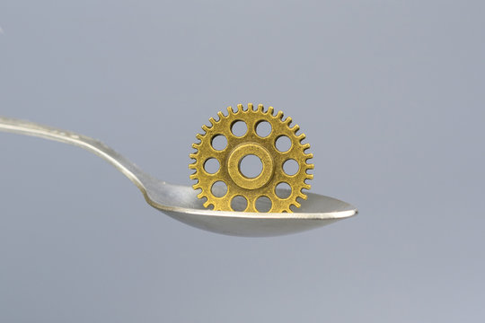 detail similar to a gear in a tablespoon on a gray