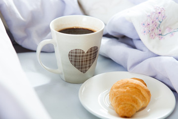 Bedroom on the bed, morning coffee. Happiness. A heart.