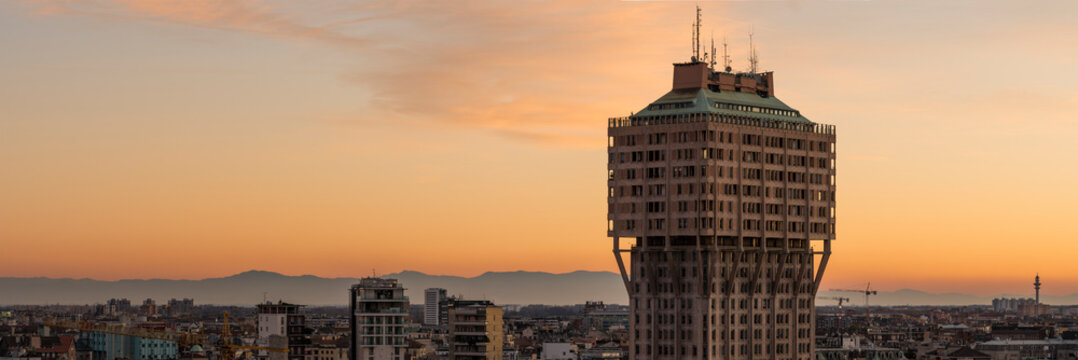 Milan (Italy) skyline with Velasca Tower (Torre Velasca) at sunset. This famous skyscraper, approximately 100 metres tall, was built in the fifties.
