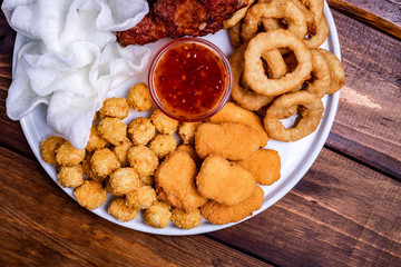 deep-fried beer snacks: chicken nuggets, balls and legs, rice flakes and breaded onion rings
