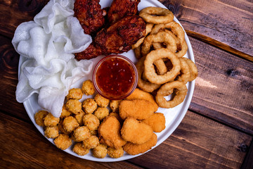 deep-fried beer snacks: chicken nuggets, balls and legs, rice flakes and breaded onion rings