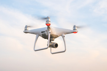 Flying drone with blue sky background