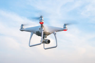 Naklejka na ściany i meble Flying drone with blue sky background